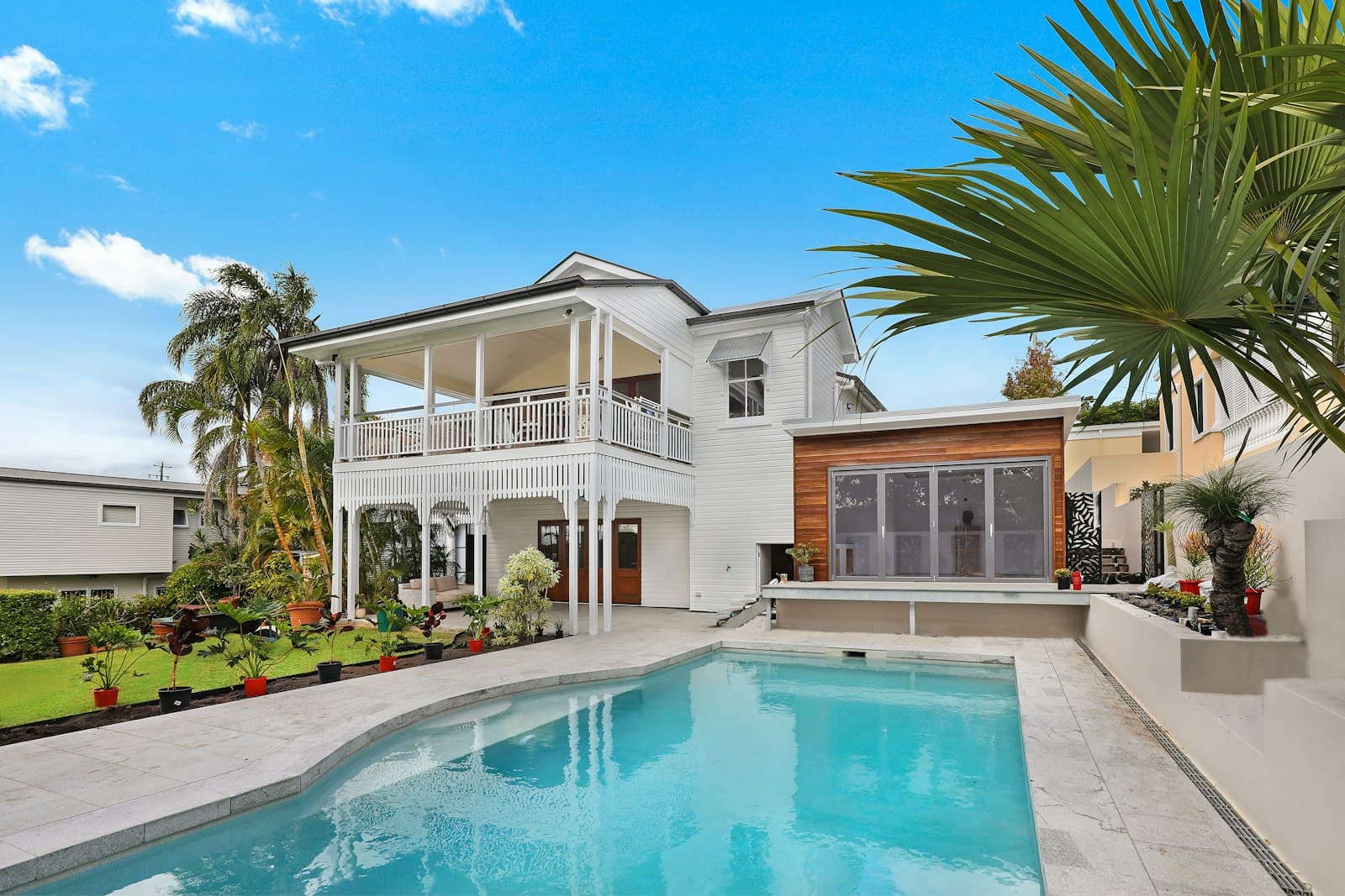 Two-story home with landscaping and a finished roof
